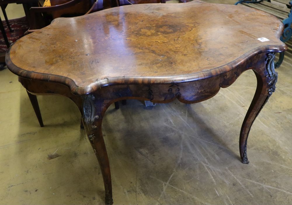 A Victorian figured walnut centre table of serpentine form, with ormolu mounted cabriole legs, width 130cm, depth 89cm, height 74cm